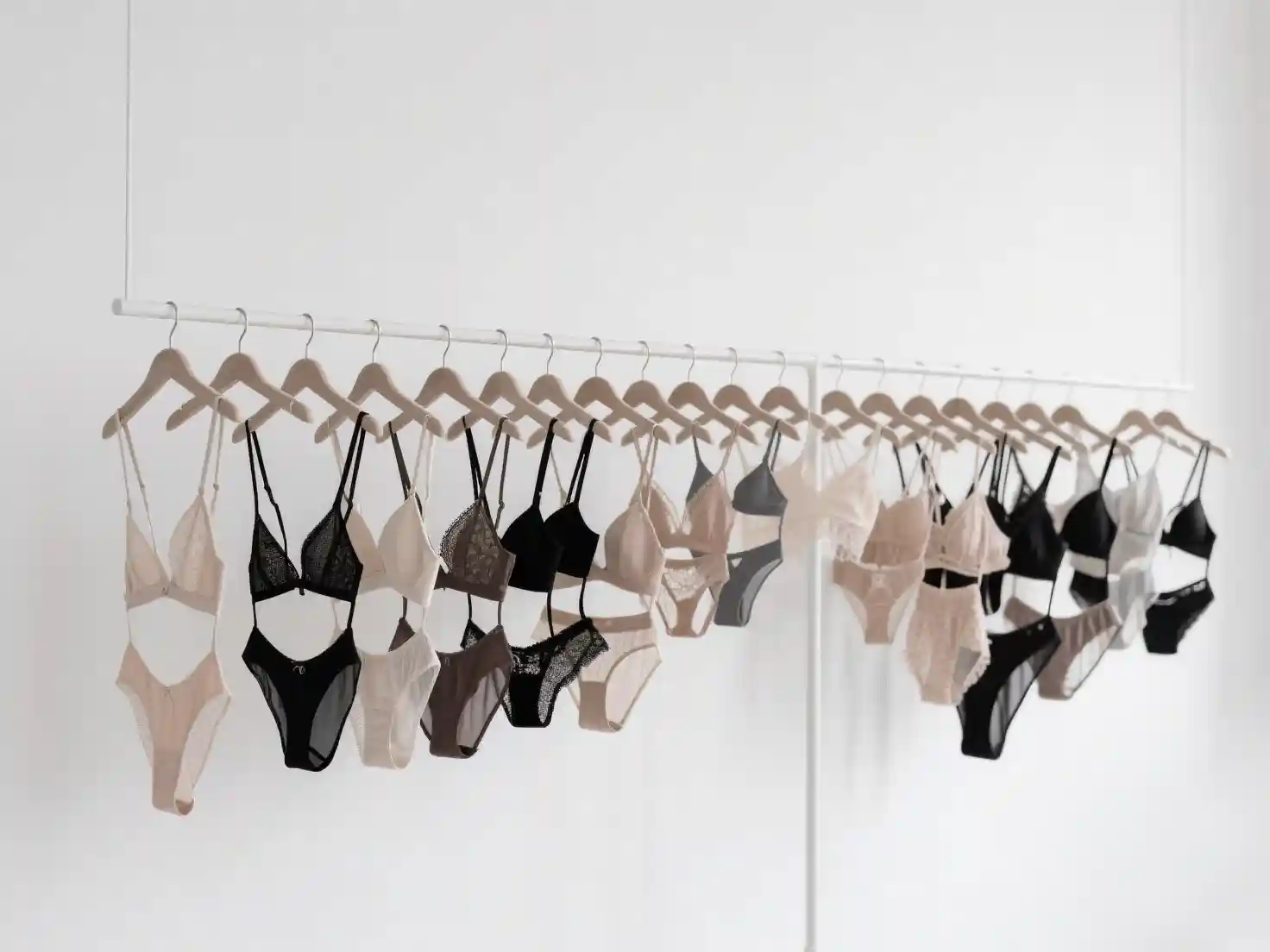 首页Quality Clothing Manufacturer With Comprehensive Services021 zoralinkcom Variety of lingerie styles hanging on white background diverse undergarment manufacturer