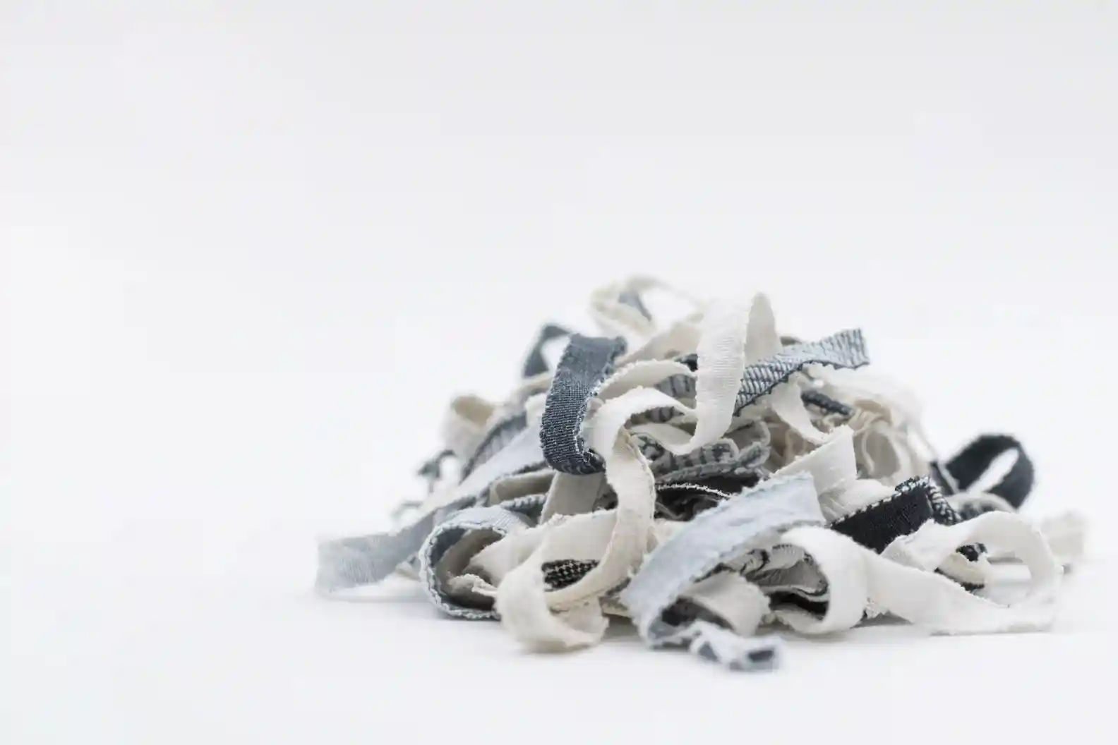 Scrap fabric pile representing recycled textiles and plastic eco friendly underwear manufacturer