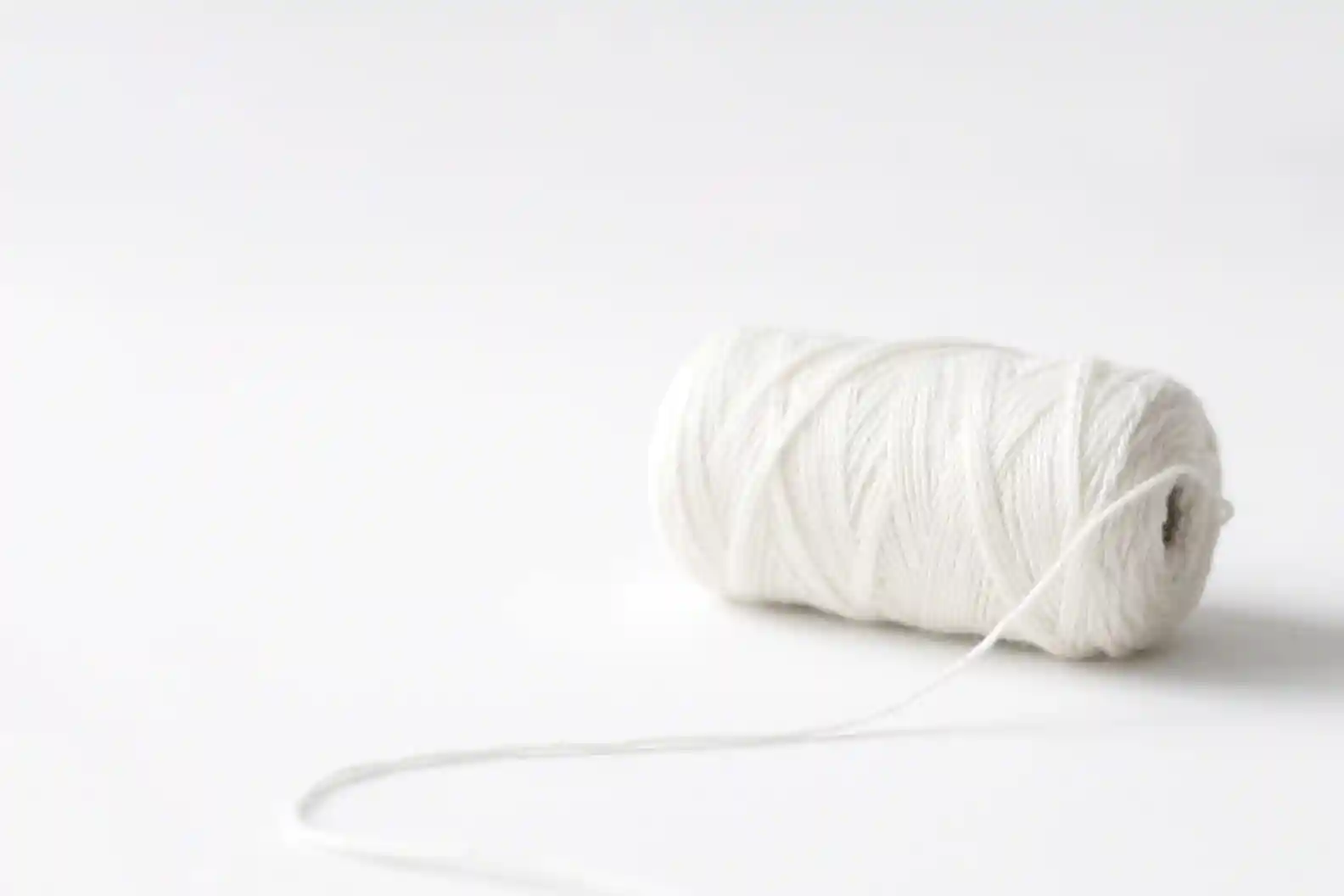Spool of recycled white yarn lingerie made from regenerated microfiber