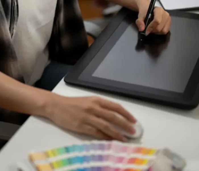 Image of a person using a graphic tablet, indicative of the digital design process in women's lingerie. Demonstrates the capabilities of lingerie manufacturers in creating custom and OEM designs for womens lingerie.