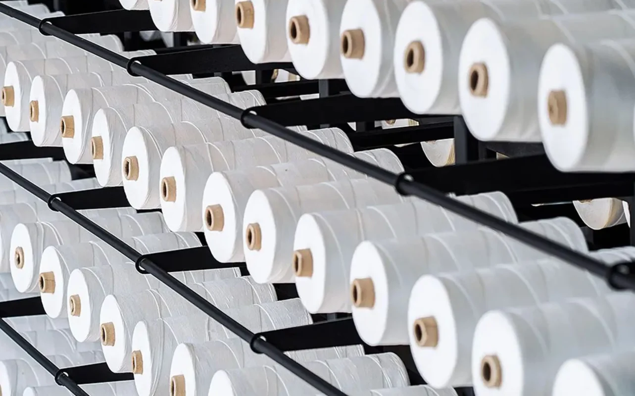 Neatly arranged spools of sewing thread, representing the high - quality material sourcing by top lingerie manufacturers. Appeals to clients seeking wholesale womens lingerie, highlighting the commitment to using the best materials in production.