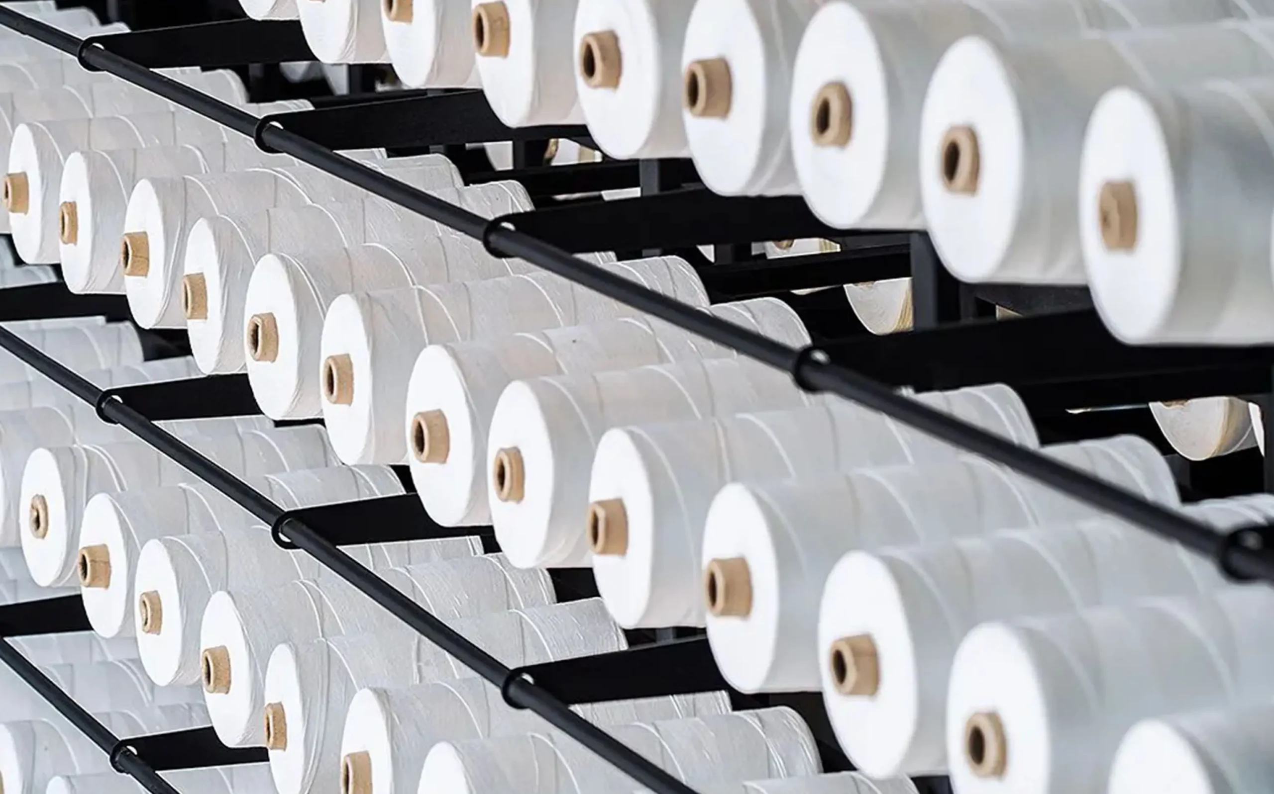 Finding the Best Lingerie Manufacturers for Your Business zoralinkcom Neatly arranged spools of sewing thread representing the high quality material sourcing by top lingerie manufacturers Appeals to clients seeking wholesale womens lingerie highlighting the commitment to using the best materials in production