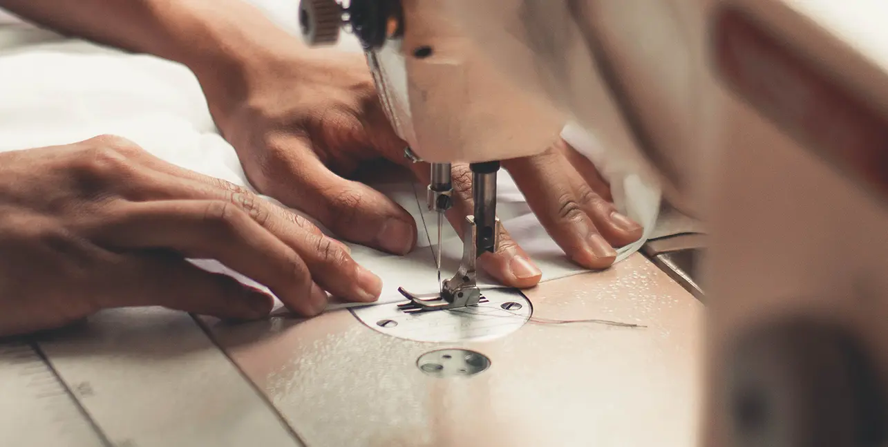 How to Design Custom Lingerie with Lingerie Manufacturers01 zoralinkcom hands operating a sewing machine highlighting the craftsmanship involved in creating womens lingerie Demonstrates the skill of lingerie manufacturers in producing custom and OEM womens lingerie with precision