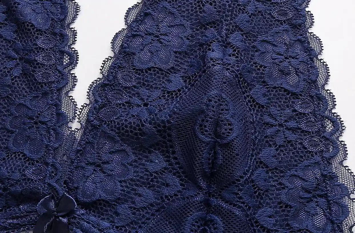 Close - up of navy blue lace bra with soft, wireless and seamless floral - patterned lace and bow detail
