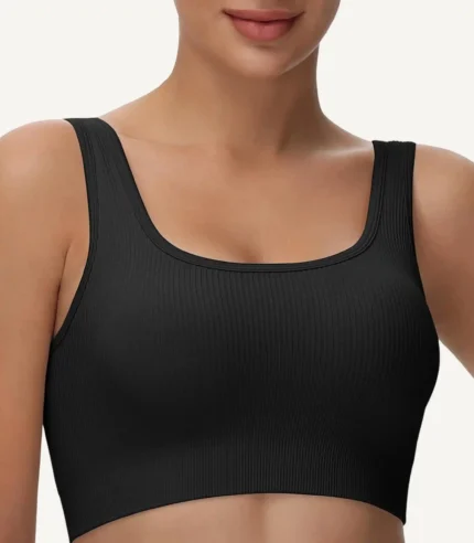 A black seamless sports bra with a ribbed texture, designed for comfort and support, made from stretchy material.