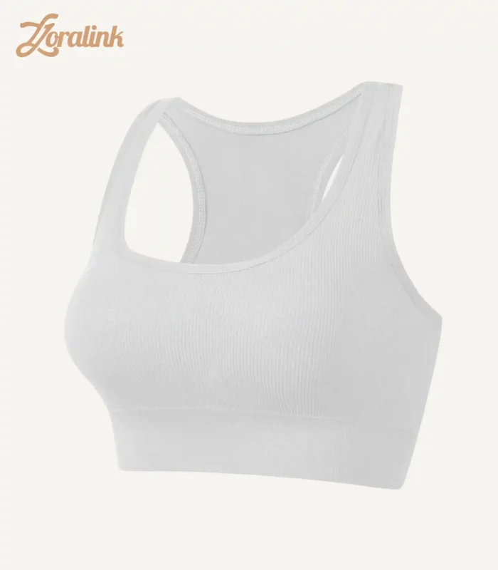 A white seamless sports bra with a ribbed texture and racerback design crafted from stretchy material for comfort and support