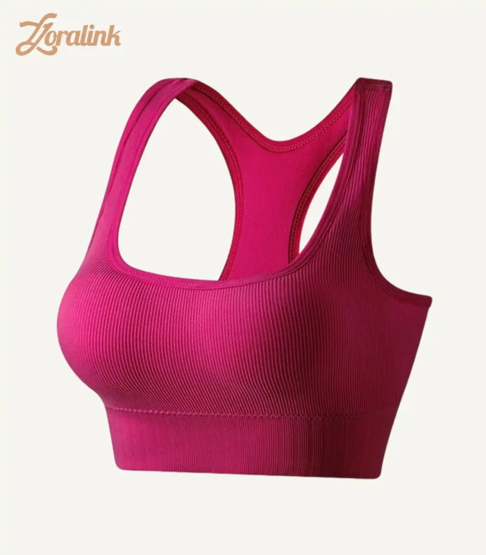A seamless bright pink sports bra with a ribbed texture and racerback design made from stretchy material for comfort and support