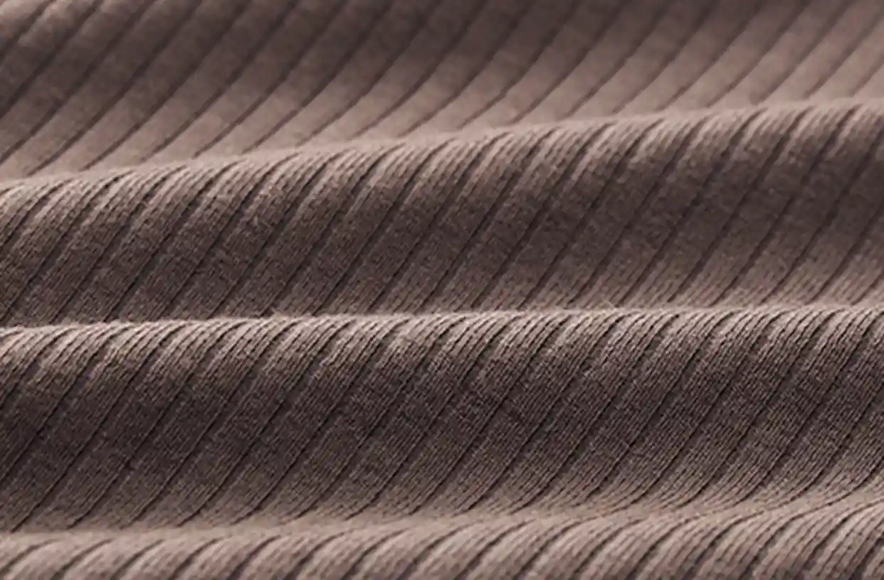 Ribbed Sports Bras Wireless Lightweight Stretchy12 zoralinkcom Close up of a brown ribbed fabric highlighting its texture and stretch indicative of the material used in seamless sports bras
