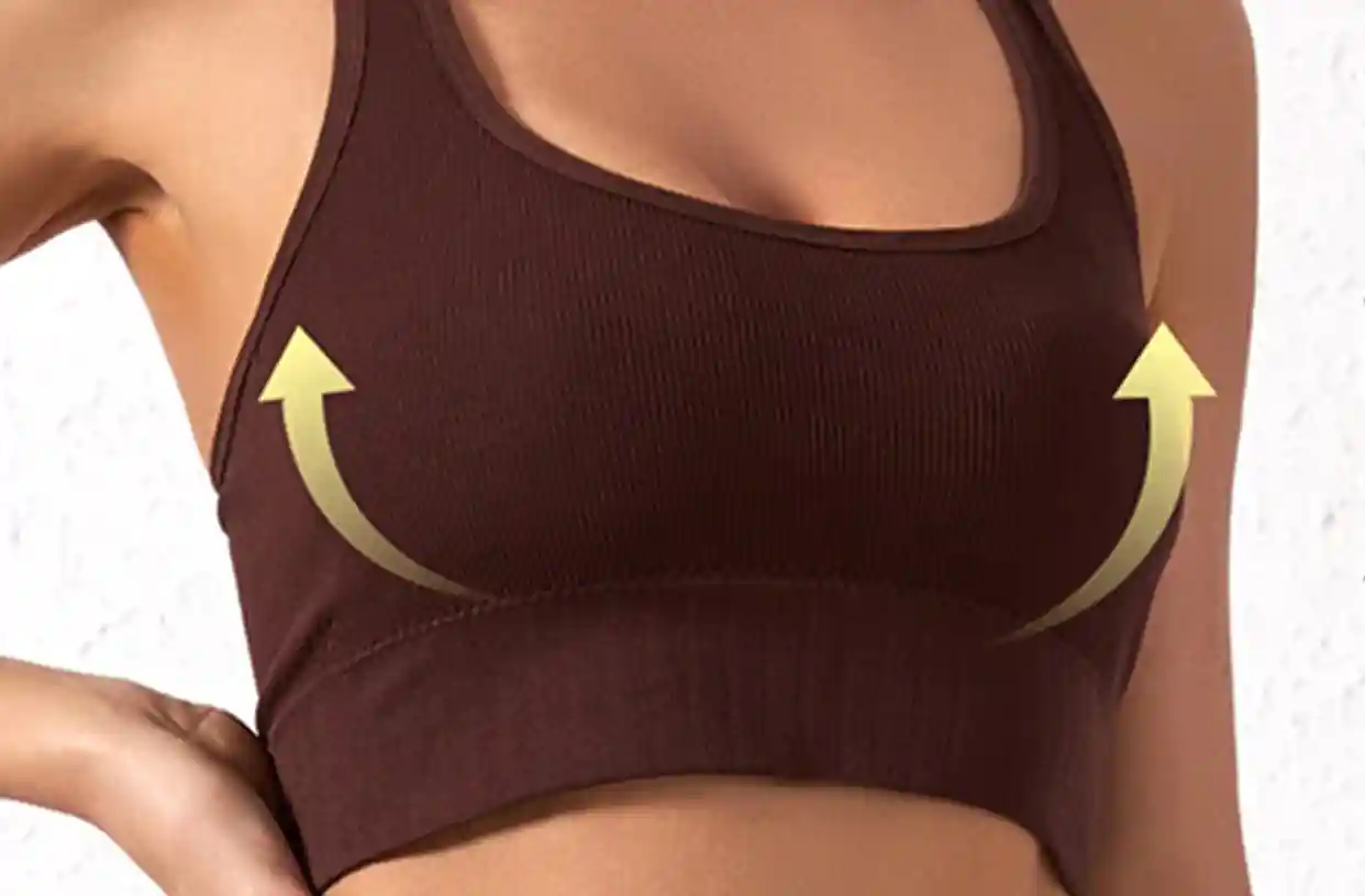 Ribbed Sports Bras Wireless Lightweight Stretchy13 zoralinkcom A person wearing a brown ribbed seamless sports bra with golden arrows indicating the bras supportive and shaping features