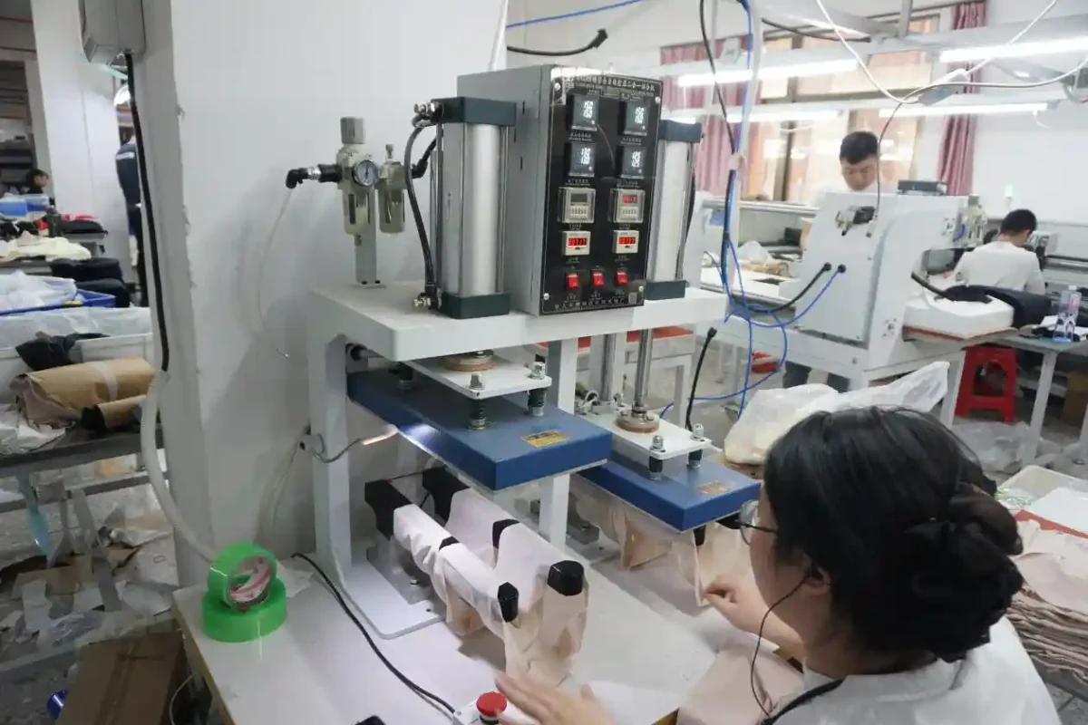 A worker operating industrial machinery in a factory setting surrounded by equipment and materials showcasing the production processes of underwear suppliers and vendors