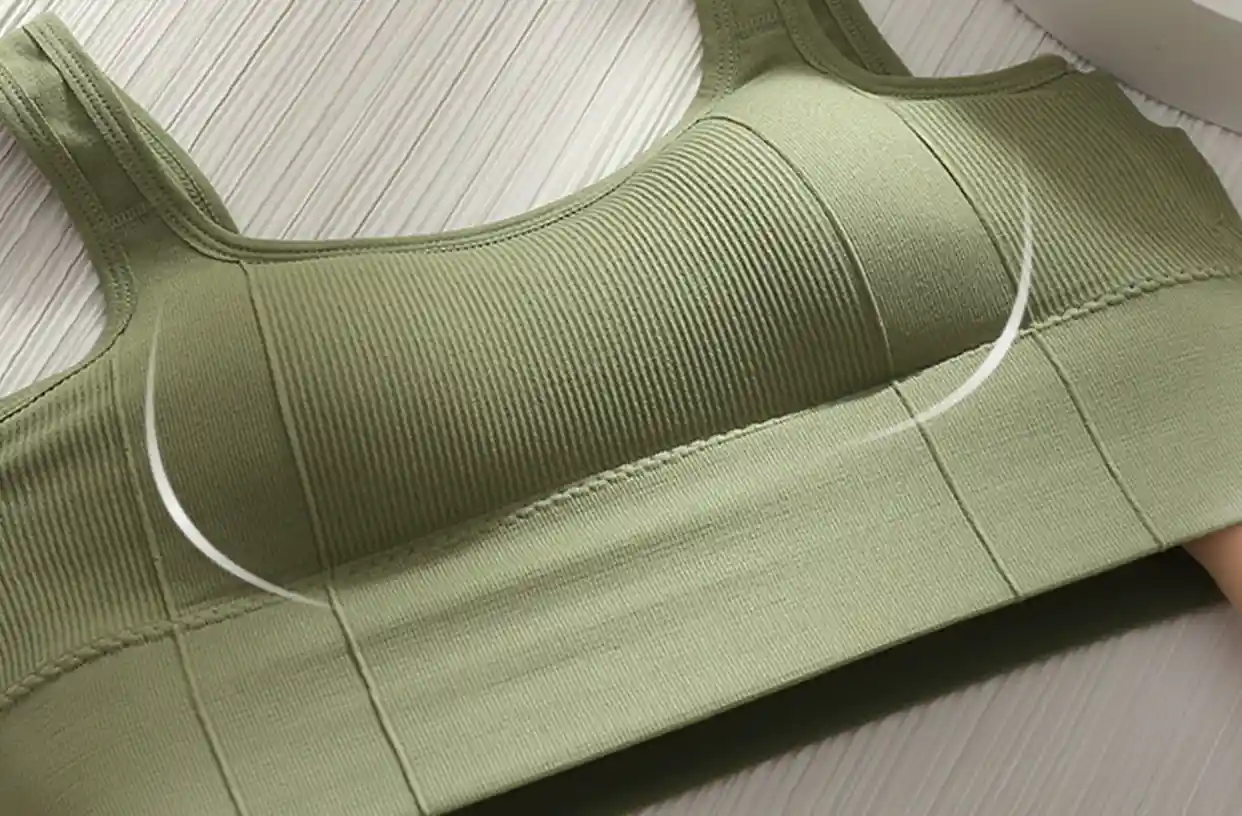 Square Collar Sports Bra11 zoralinkcom Green seamless sports bra being stretched showcasing its high elasticity and square neck design for fitness activities