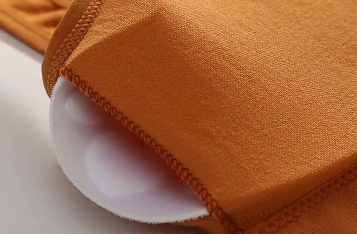 Square Collar Sports Bra13 zoralinkcom Close up of removable padding on an orange seamless sports bra featuring square neck design and adjustable support for fitness activities
