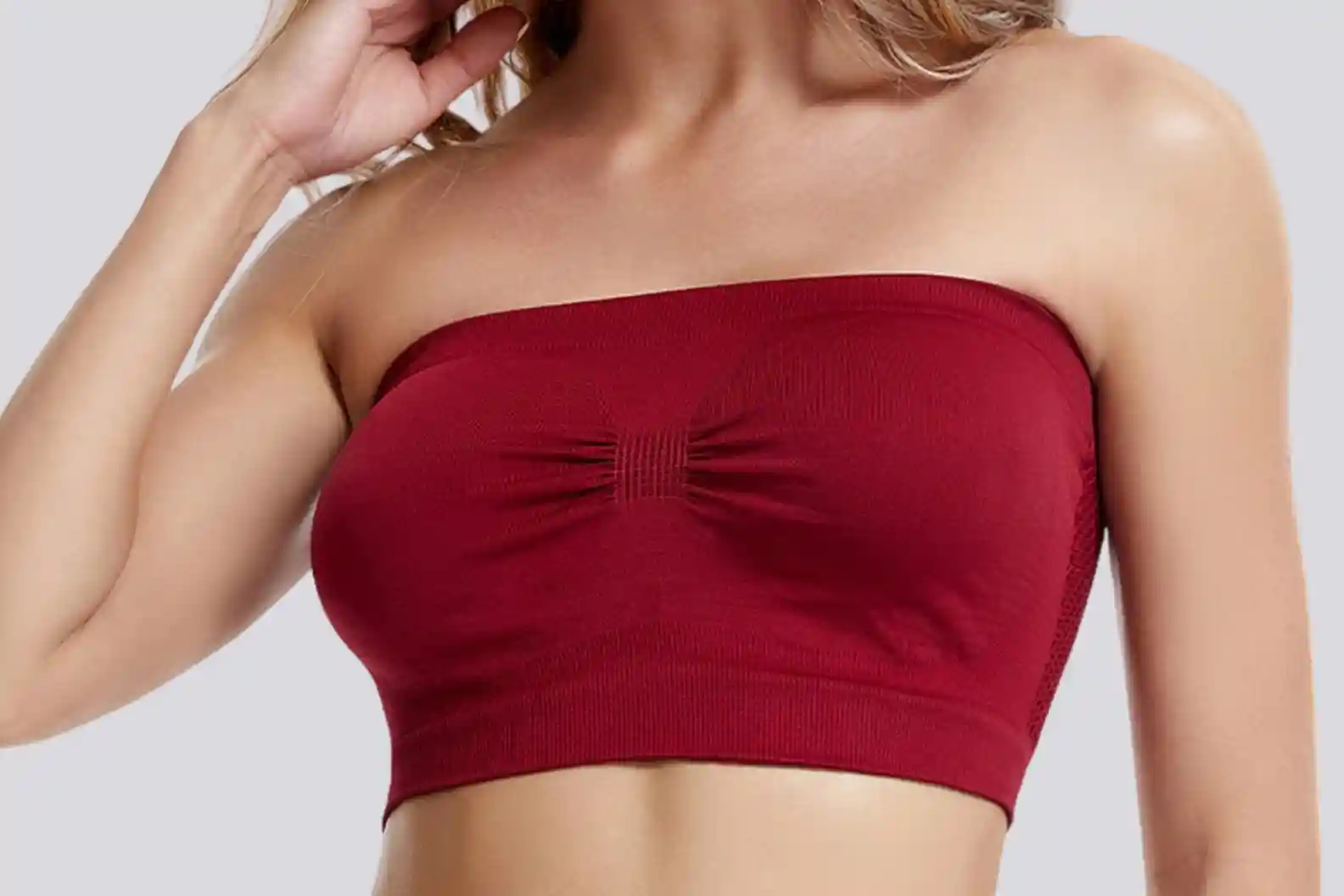 Woman in red strapless bra showcases anti-slip grip and seamless design for confident movement