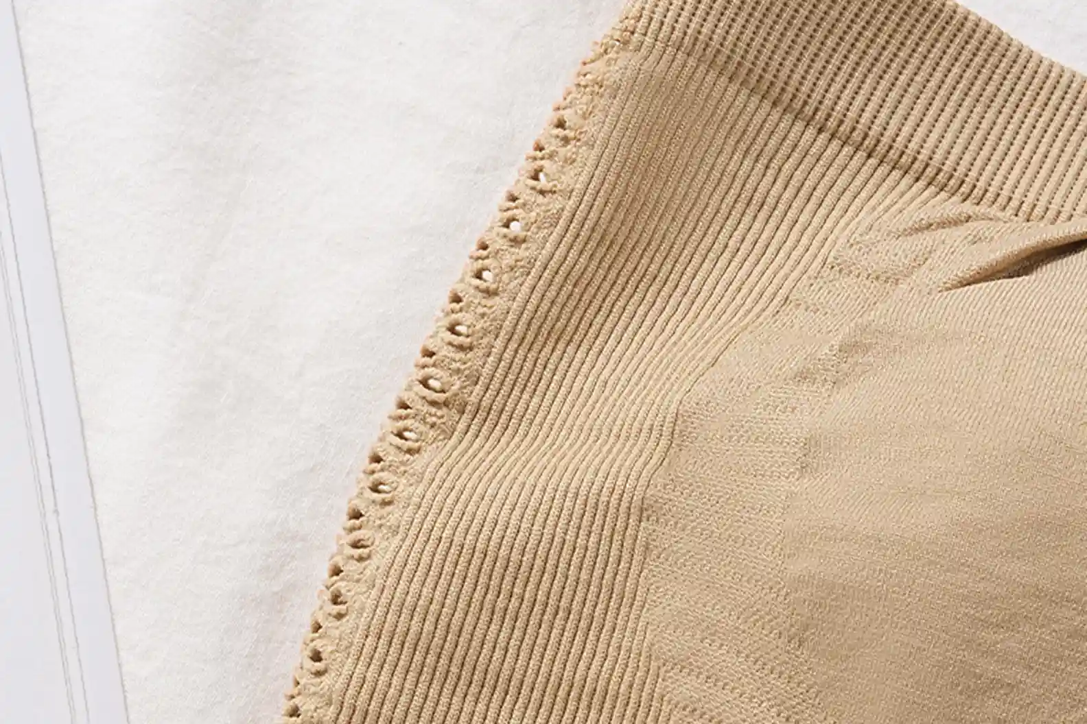 Close-up of the breathable and stretchy fabric used in a wireless strapless bra, highlighting its comfort and anti-slip technology