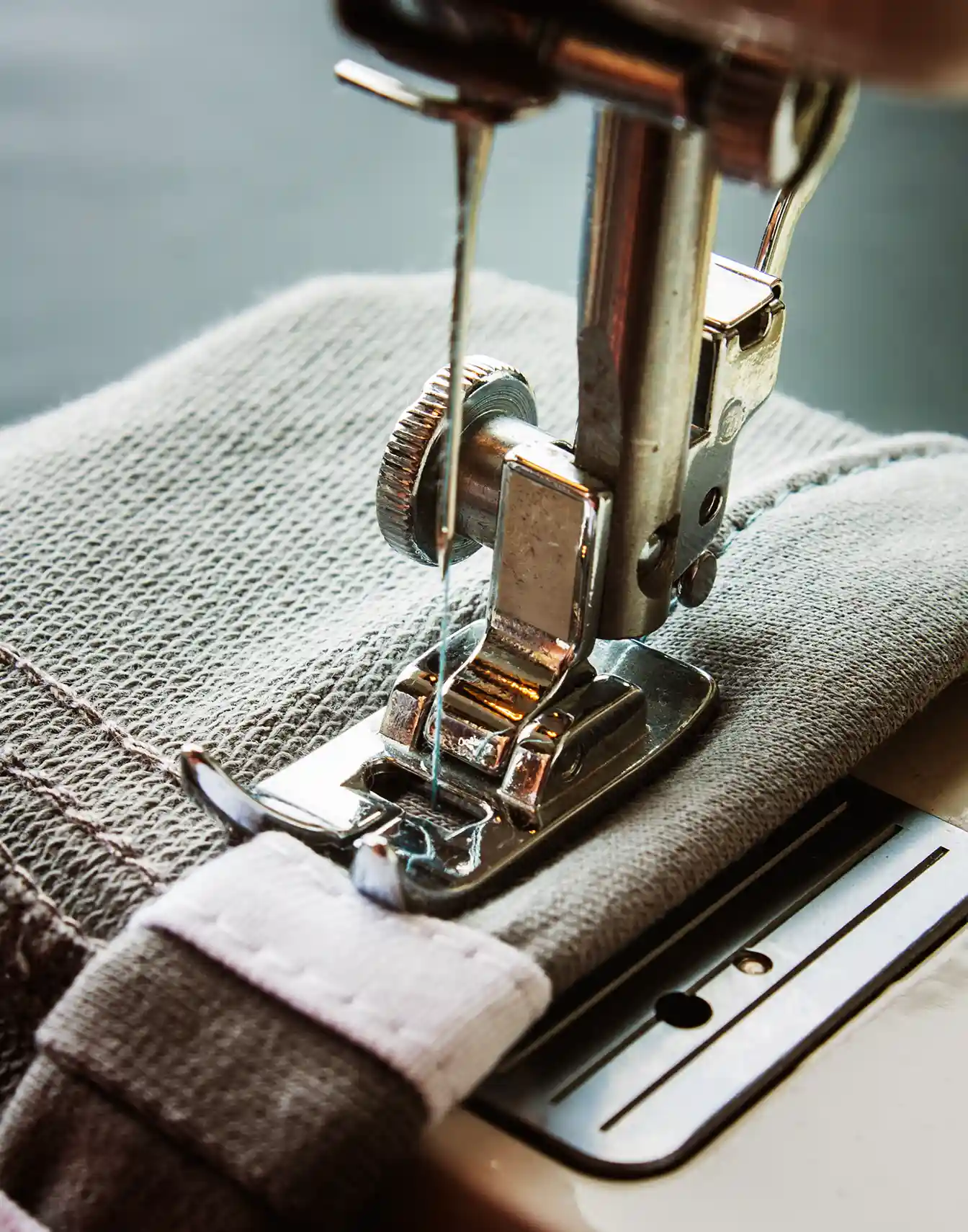 Close up of a sewing machine stitching a piece of sustainable fabric highlighting the production process of eco friendly lingerie by conscientious suppliers