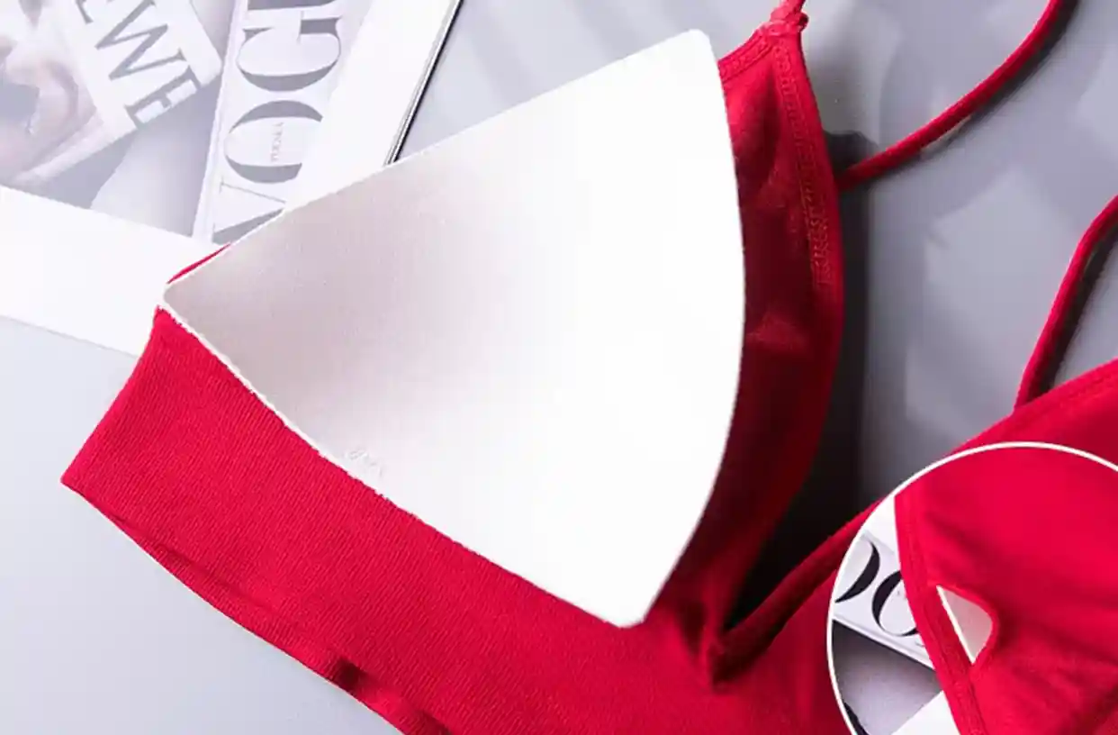 Triangle Bra Seamless Wireless Comfort Style14 zoralinkcom Close up of a red seamless triangle bra with a removable white padding insert emphasizing comfort and customizable fit