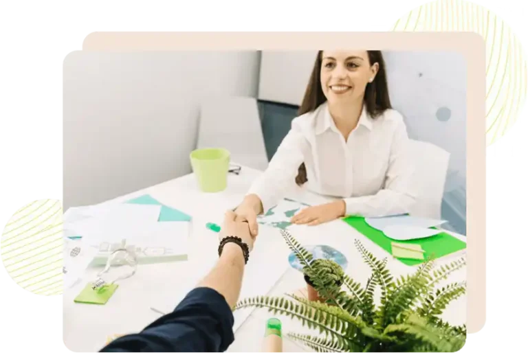 Underwear Sustainability Practices041 zoralinkcom A business handshake between two individuals at a desk surrounded by sustainable themed materials like a small potted plant and green colored stationery symbolizing partnerships in sustainable underwear production
