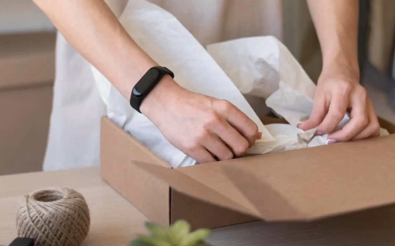 Hands carefully packaging lingerie, showcasing the attention to detail by lingerie manufacturers. Ideal for custom cut - and - sew orders with low MOQ, ensuring a delicate unboxing experience for every piece.